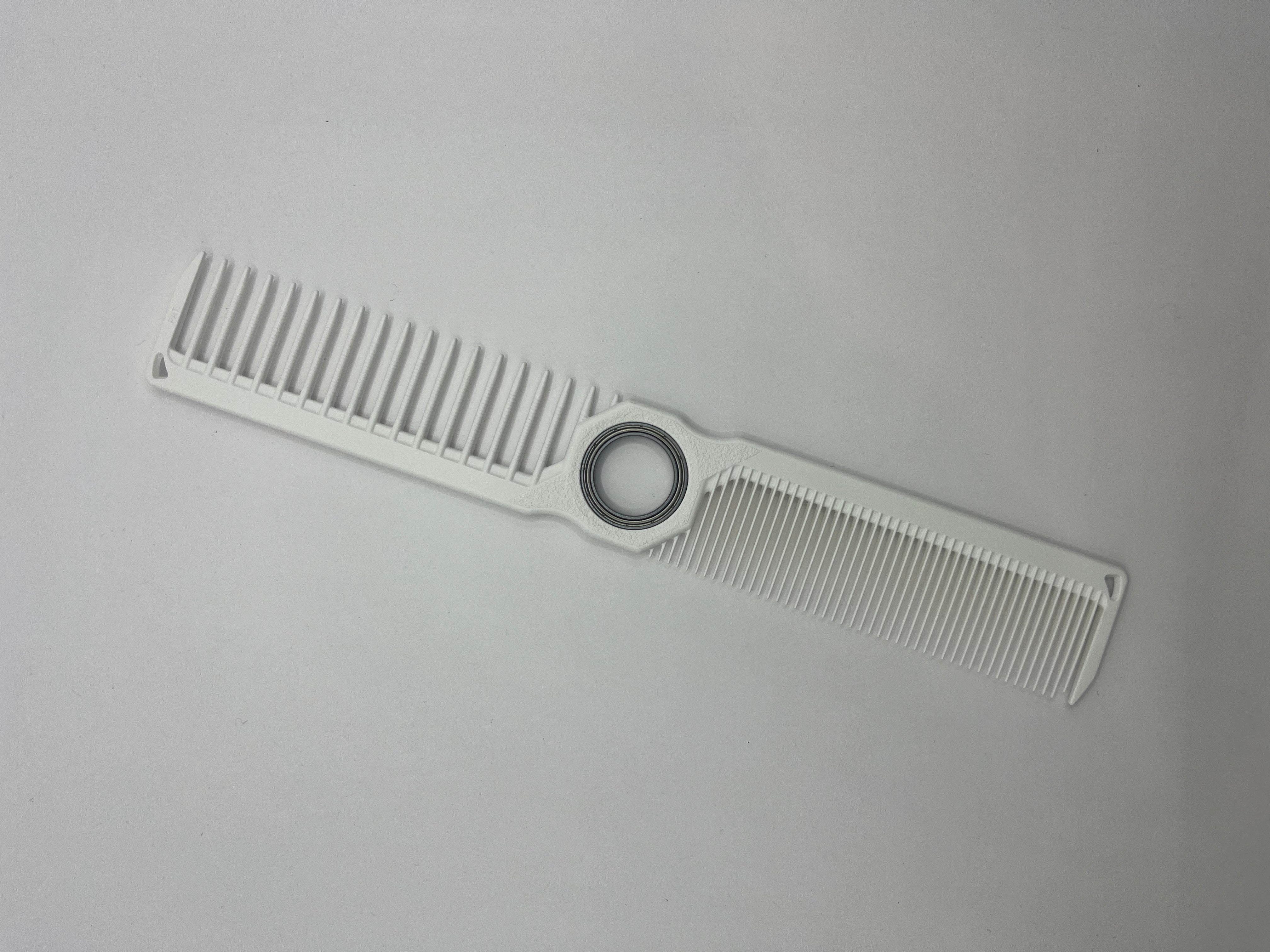 spinning white barber comb